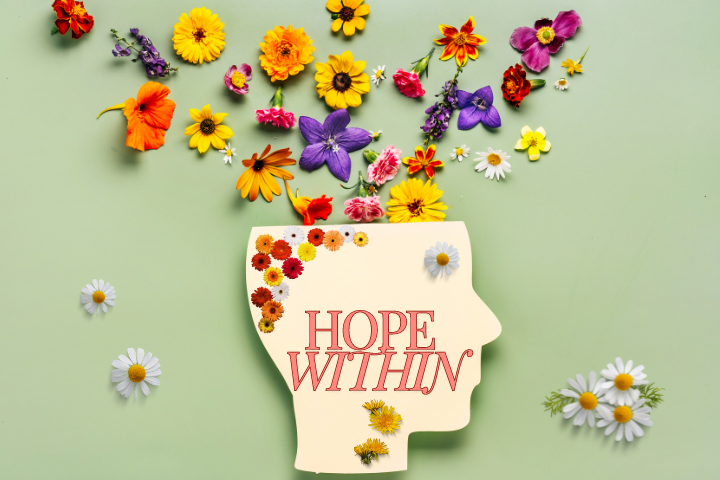 An illustration of an open head with flowers falling out of it. The words Hope Within are written on it